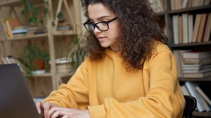 student studying on a laptop in a library